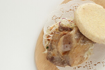 Homemade roasted pork and cabbage in English muffin sandwich