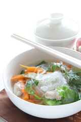 Chinese food, green leaf vegetable and glass noodles soup with carrot, and coriander leaves