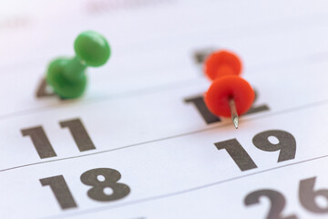 Calendar and date stamp with push pins.