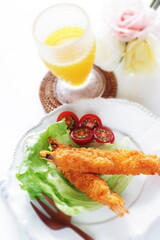Homemade deep fried prawn served with cherry tomato for Japanese food image