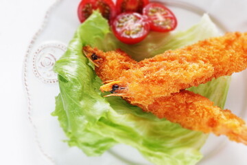 Homemade deep fried prawn served with cherry tomato for Japanese food image