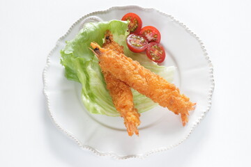 Homemade deep fried prawn served with cherry tomato for Japanese food image