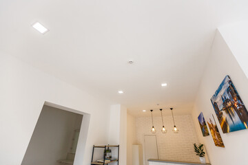 White ceiling with spot lights in room