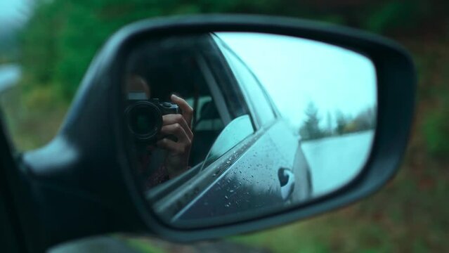 Landscape of foggy forest and road in the side view mirror reflection of car on road countryside. low sharp, low selective focus