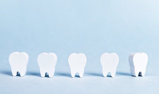Abstract teeth row on blue background. Dentistry concept