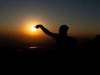 adventurous traveler's creative games with the sun at sunrise time