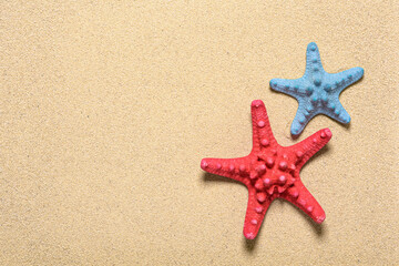 Fototapeta na wymiar Two starfishes at the beach sand.