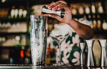 man bartender making cocktail in bar.