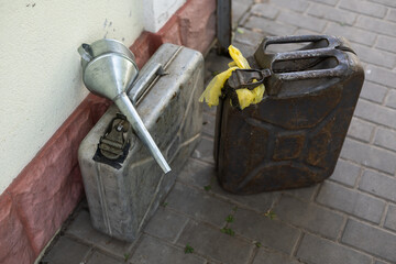 canister and watering can for diesel. the canister with the fuel and the filler funnel.