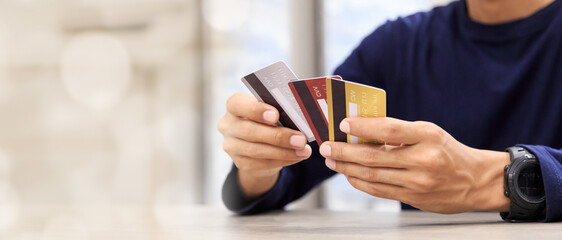 Online payment hand holding credit card and using laptop. Online shopping concept.
