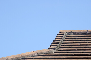 Abstract of a section of roof on a resedential house with clear blue sky background for copy space