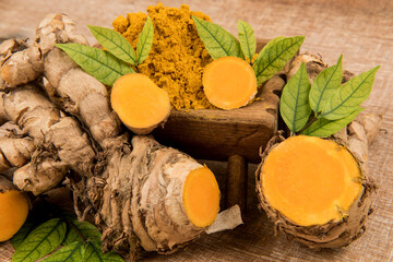 Curcuma aromatica or wild turmeric rhizome on an old background.