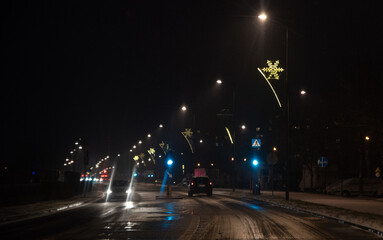 Legionowo, Poland - December 5, 2021: The city before Christmas. Christmas illuminations in Legionowo. Street at night, decorated with lanterns.