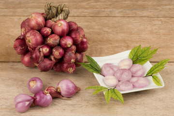 Red shallots on an old wood background.