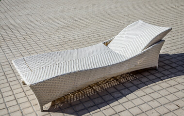 Fototapeta na wymiar White rattan furniture near the pool