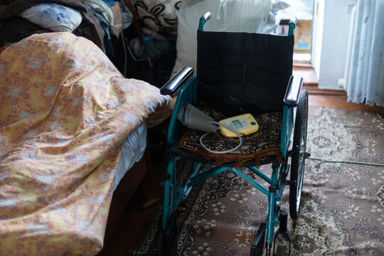 Empty Wheelchair In A Very Poor Old House