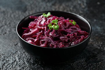 Braised Red Cabbage with apples and redcurrant in black bowl
