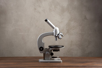 Back to school - microscope on the wooden desk in the auditorium, Education concept