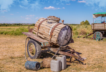 Old abandoned water barrel on wheels