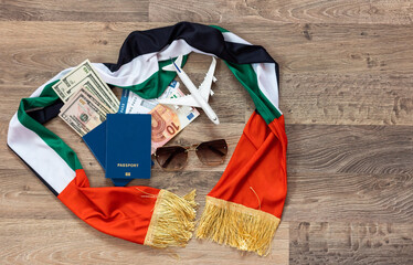 Plane over the flag of the United Arab Emirates United Arab Emirates travel concept. Toy plane on a flag scarf