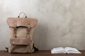 Back to school - books and school backpack on the desk in the auditorium, Education concept.