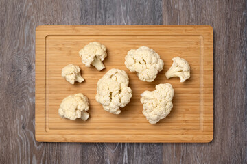 Cauliflower inflorescences on a kitchen board, vegetarian food