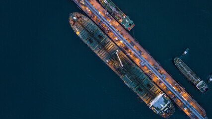 Aerial view tanker ship vessel unloading at port at night, Global business logistic import export...