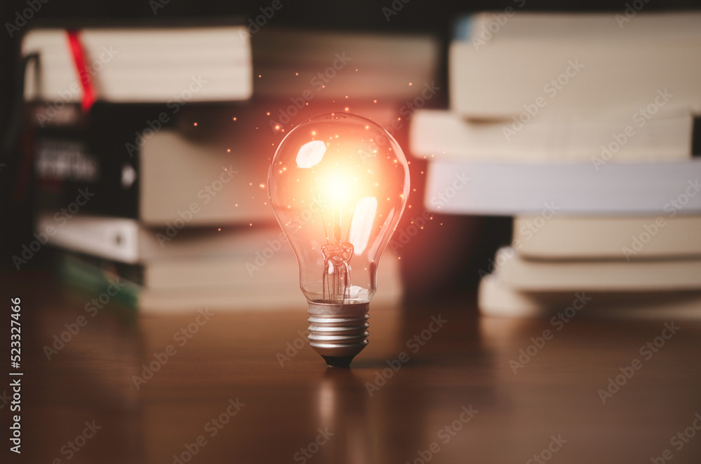 Poster glowing lightbulb in front of heap of books for education of creative thinking innovation idea and p