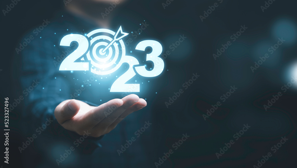 Poster businessman holding virtual 2023 number with blue dartboard and copy space for merry christmas and h