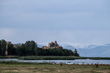 landscape with an old stone church in a picturesque place against the blue sky in Armenia