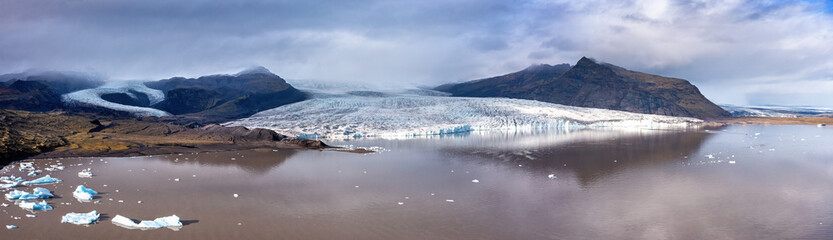 Panorama of Fjallsarlon glacier lagoon, Southern Iceland. Part of the Vatnajokull Glacier, the largest ice cap in iceland. Wide panoramic drone shot