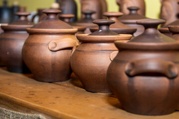 Fototapeta na wymiar Clay pots. Some clay terracotta pots for food for sale at a craft store.