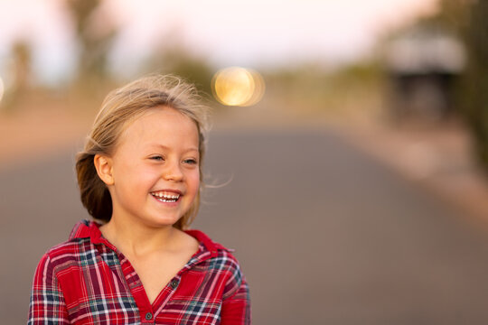 happy smiling little girl outdoors at sunset