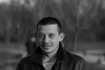 Portrait of a man in park in black and white