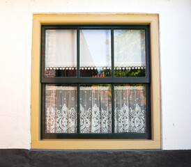 Window of cozy house with vintage curtains