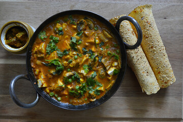 Paneer curry in iron pan