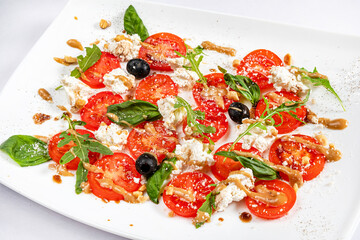 Traditional italian caprice salad tomato mozzarella cheese and basil