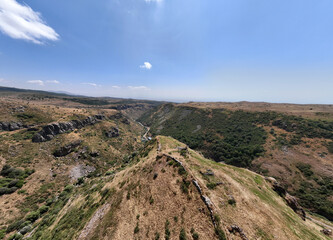panoramic view of a mountain landscape with an old Christian church against the sky in Armenia taken from a drone