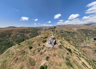 Fototapeta na wymiar panoramic view of a mountain landscape with an old Christian church against the sky in Armenia taken from a drone
