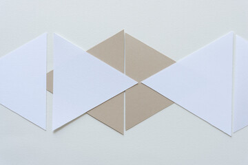 geometric shapes arranged on paper - beige and white triangles