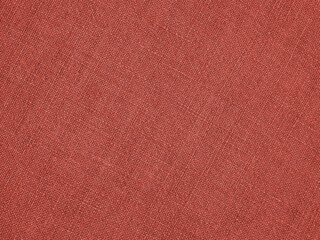 Pale red woven surface close-up. Linen net texture. Dark fabric len background. Textured braided backdrop
