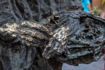 bronze hands with rose flower closeup
