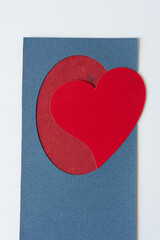 grungy paper heart on blue frame with red paper