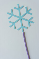 blue paper snowflake and pipe cleaner