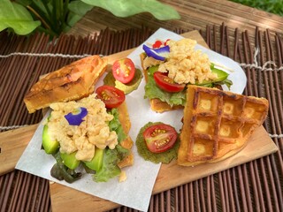 Fried egg with avocado waffle sandwiches