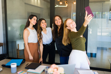 Female teamwork taking a picture for social media