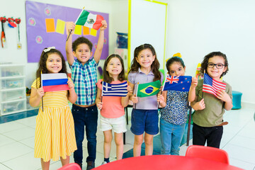 Happy preschoolers showing diverse country flags