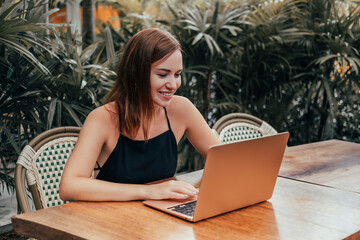 Woman Using Laptop in cafe, outdoor portrait business woman, hipster style, internet, smartphone, office, Bali Indonesia, holding, mac OS, manager, freelancer 