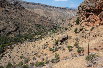 landscape with mountains and green vegetation against the blue sky on a summer day in the mountains of Armenia