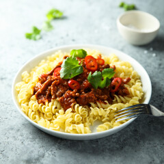 Pasta with spicy meat ragout and chili